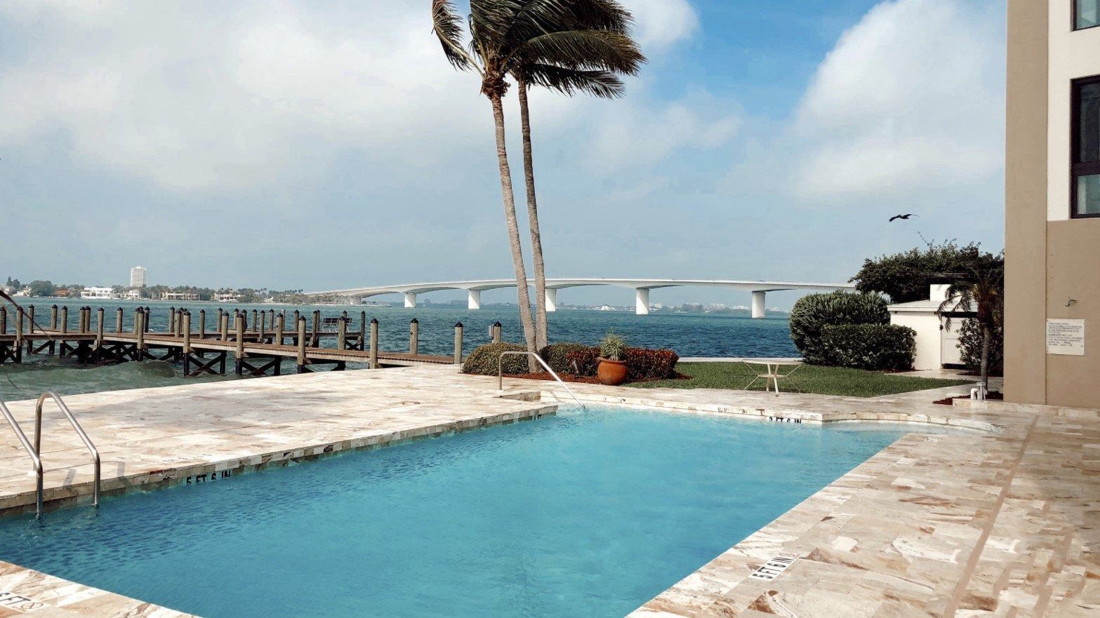 A large swimming pool with a view of the ocean