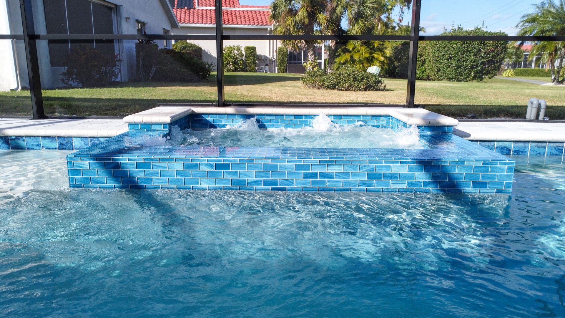 A swimming pool with a fence around it and a house in the background.