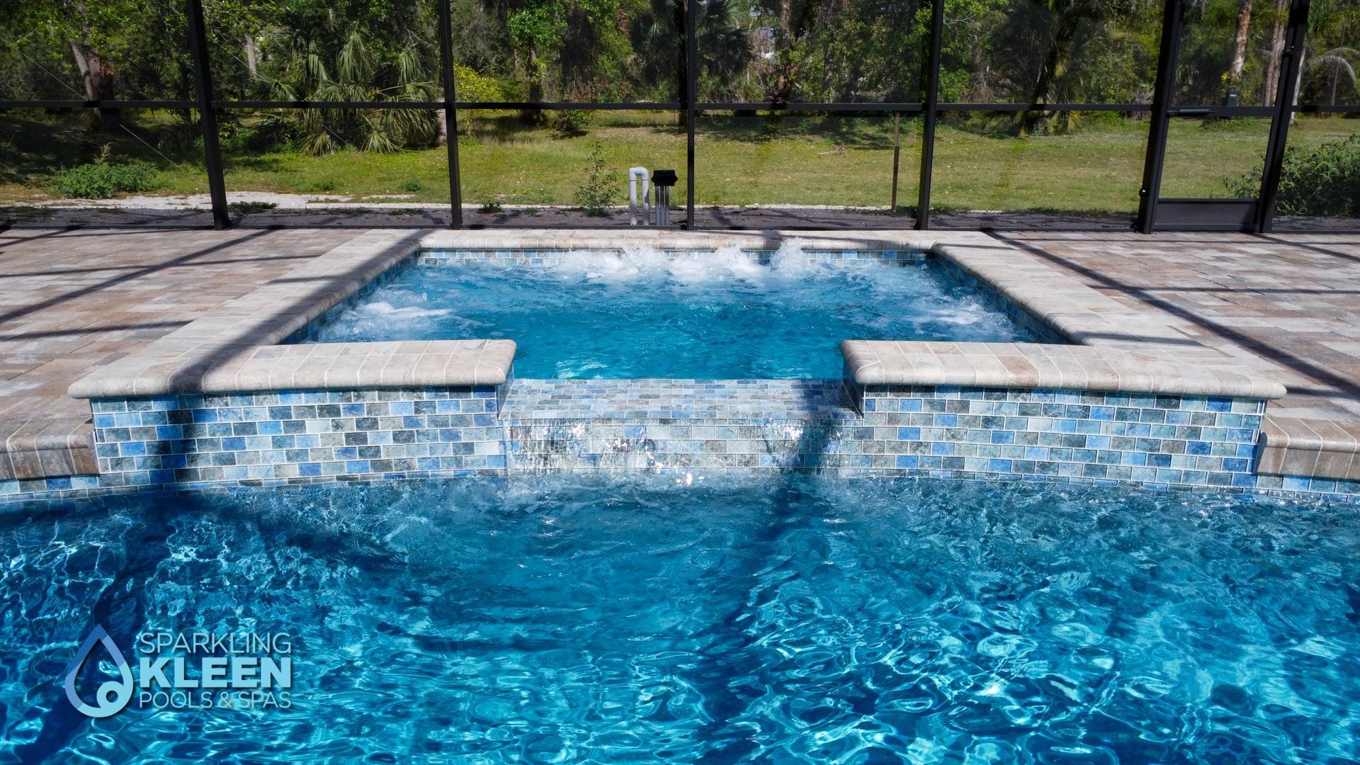 A large swimming pool with a jacuzzi in the middle of it.