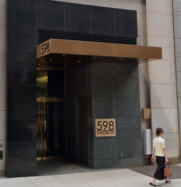 A woman walks past a building with the number 598 on it