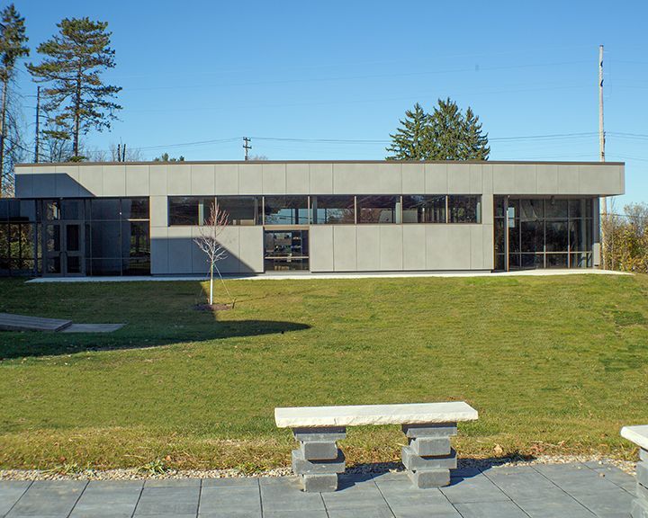 A building with a lot of windows and a bench in front of it