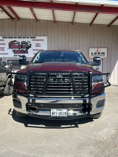 Red pickup truck with chrome grille parked outside a truck accessories shop.