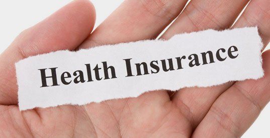 Health insurance on paper on hand