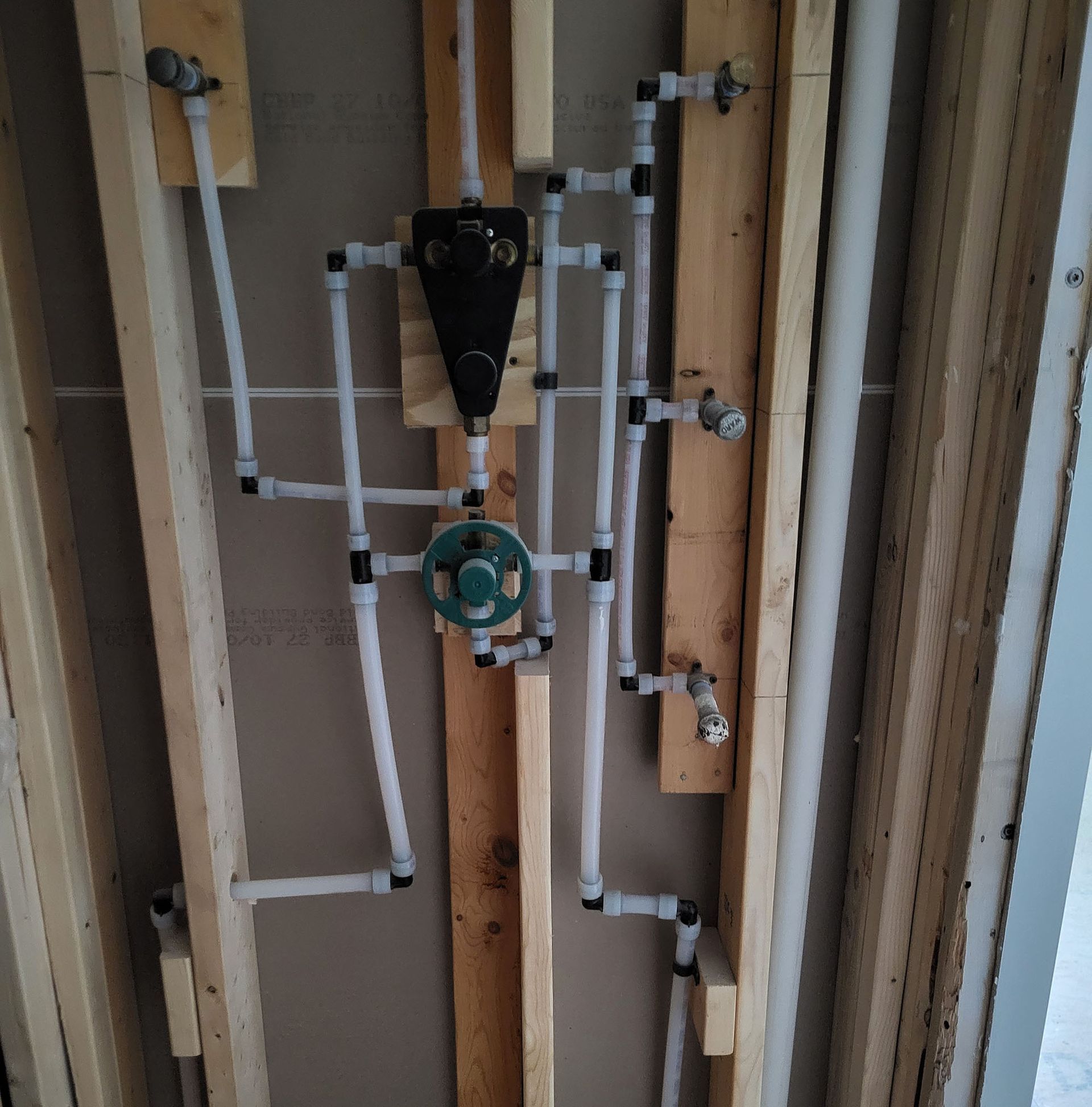 A wall with a lot of pipes hanging from it