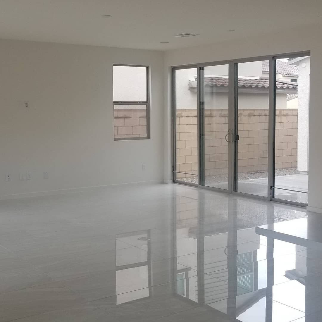 An empty room with sliding glass doors and a window