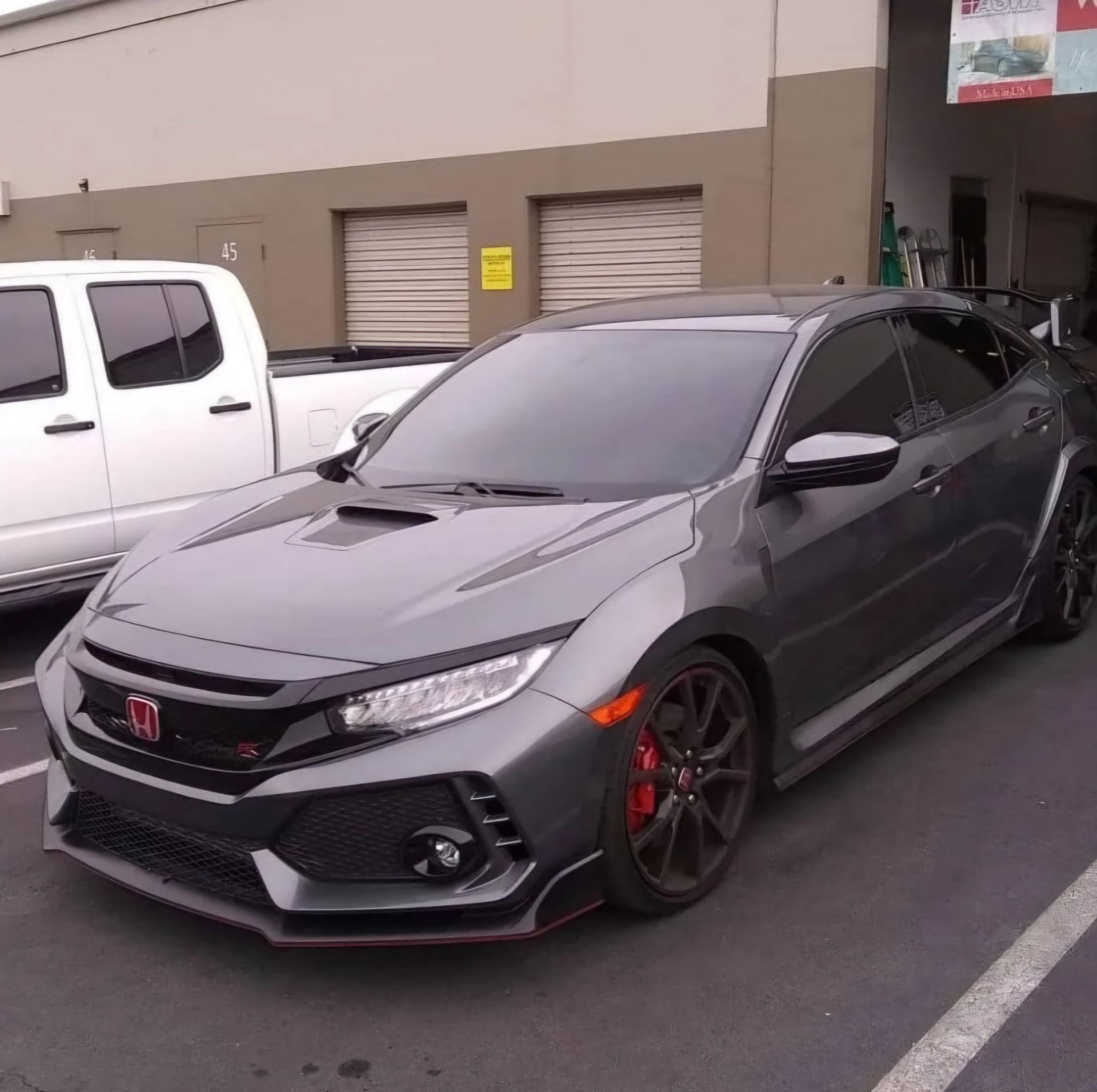 A gray honda civic is parked in a parking lot