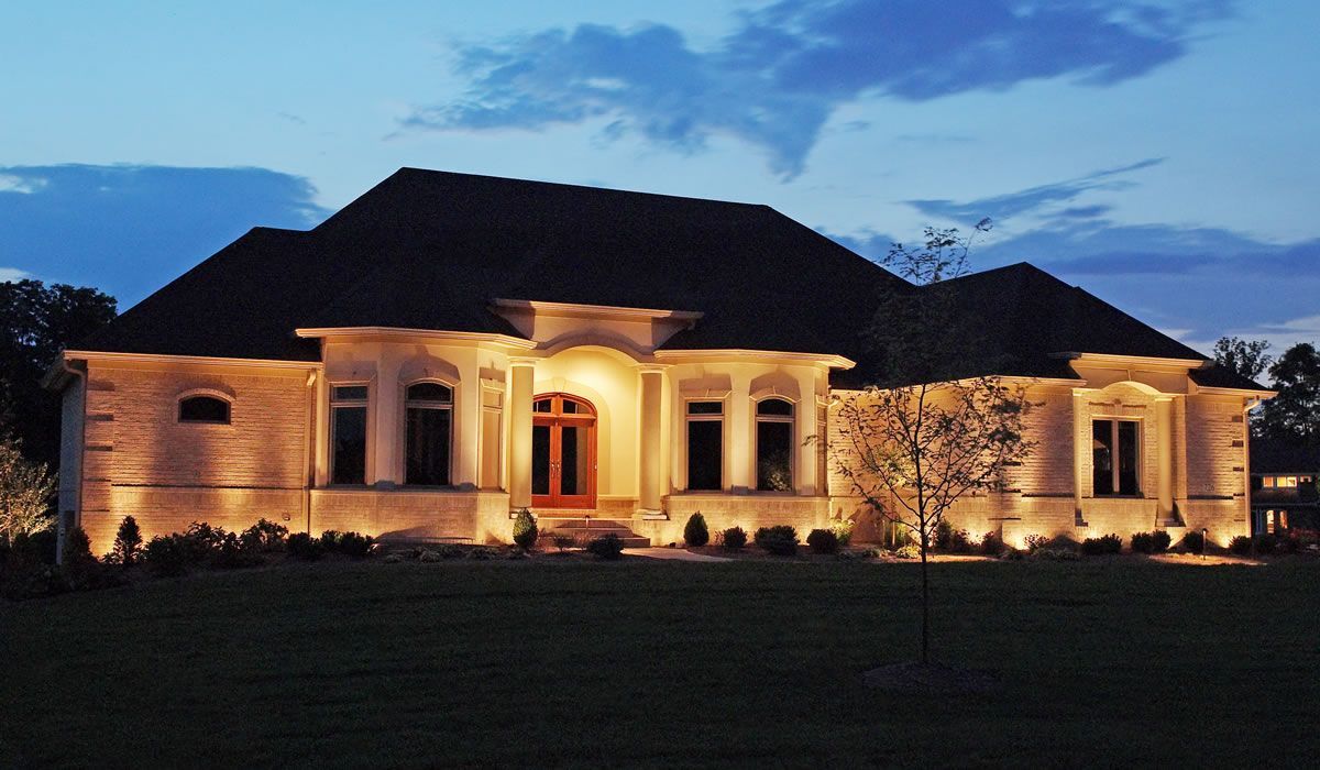 A large house that is lit up at night.