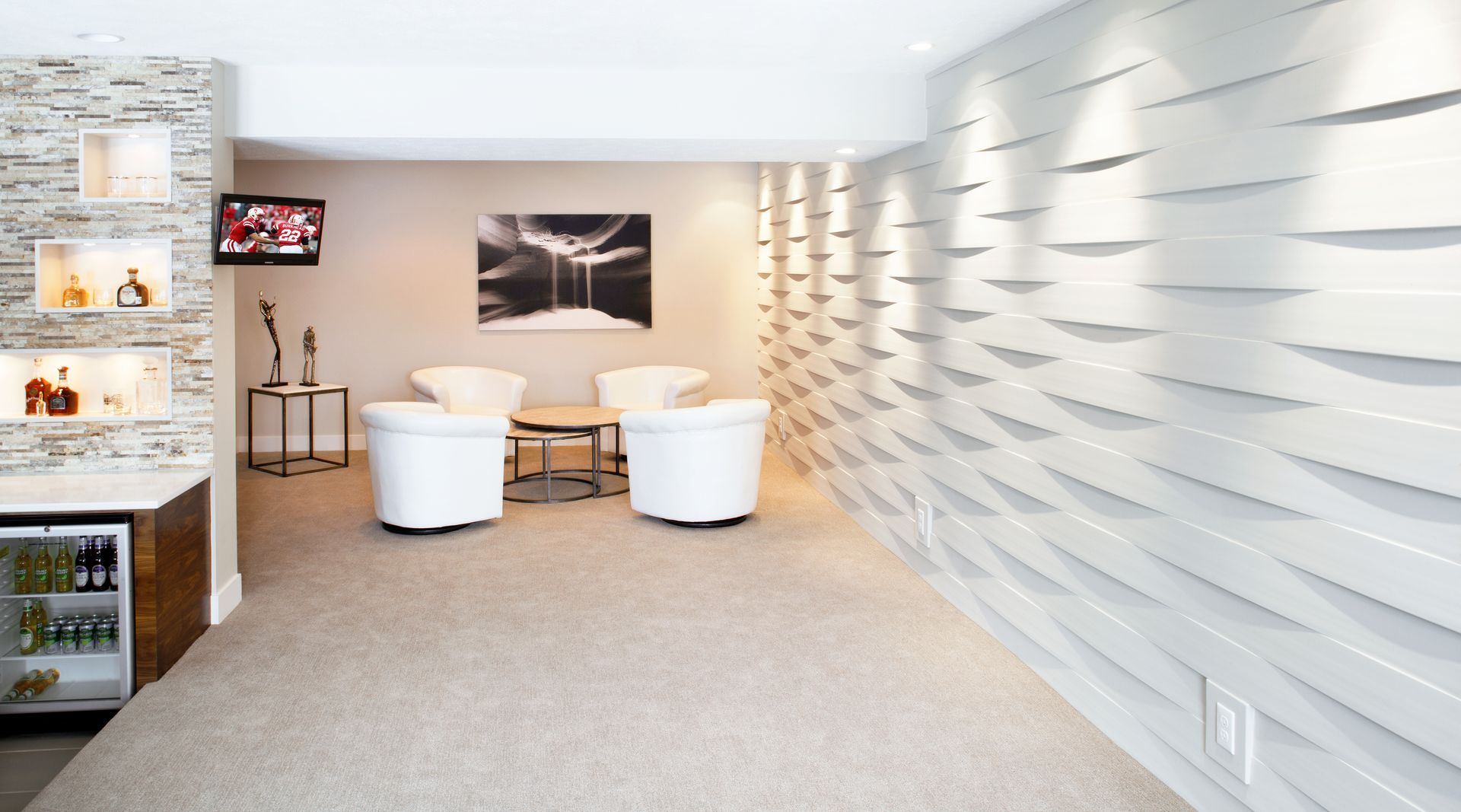 Modern white lobby with curved chairs, reception shelves, and wall art in a bright, minimalist space
