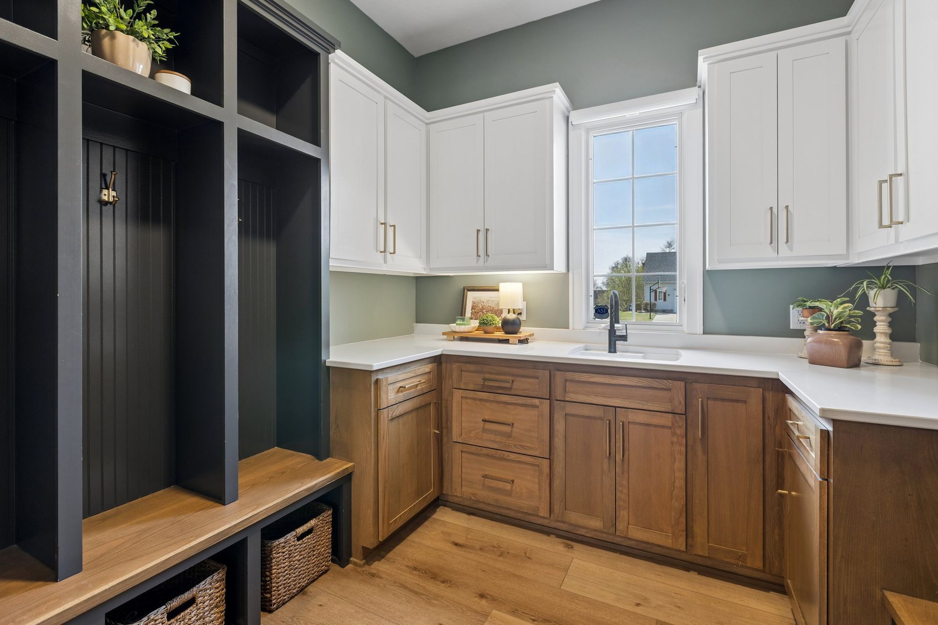 Modern kitchen with white cabinets, wood lower cabinets, open shelving, and a window over the sink.