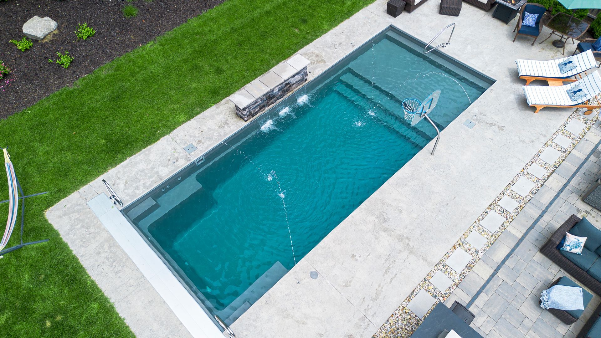 An aerial view of a large swimming pool in a backyard.