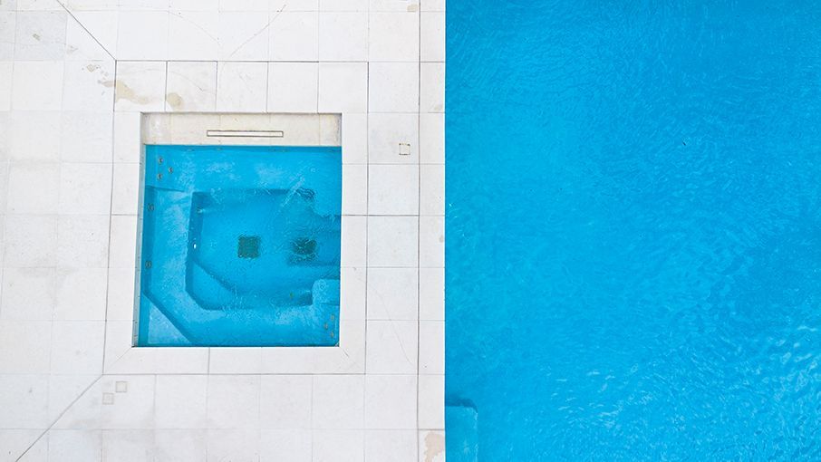 An aerial view of a swimming pool with a window in the middle of it.
