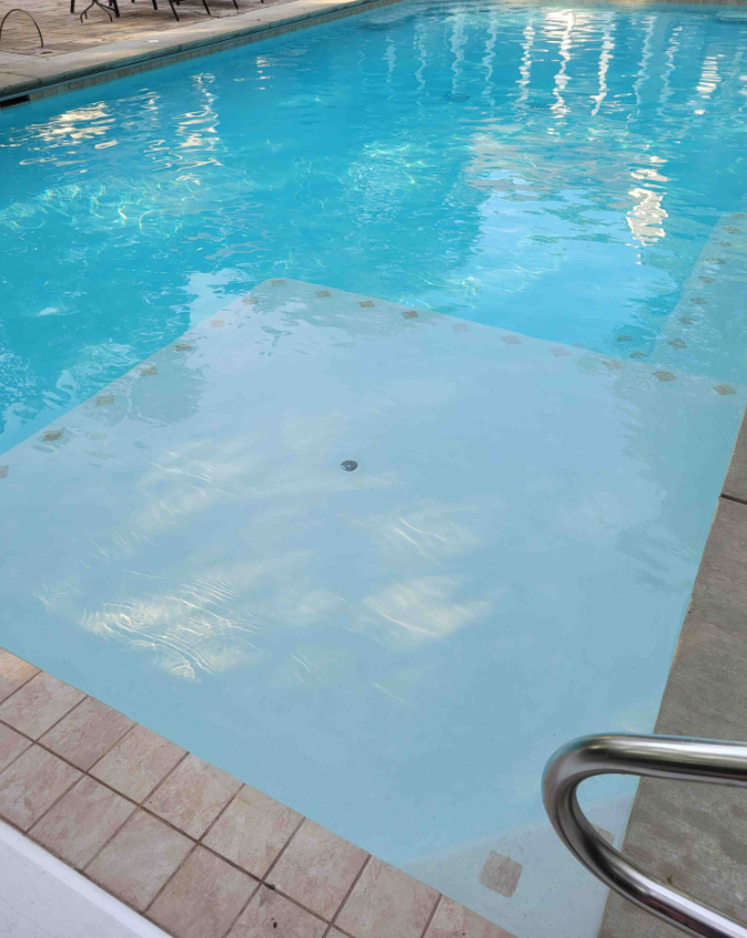A large swimming pool filled with blue water.