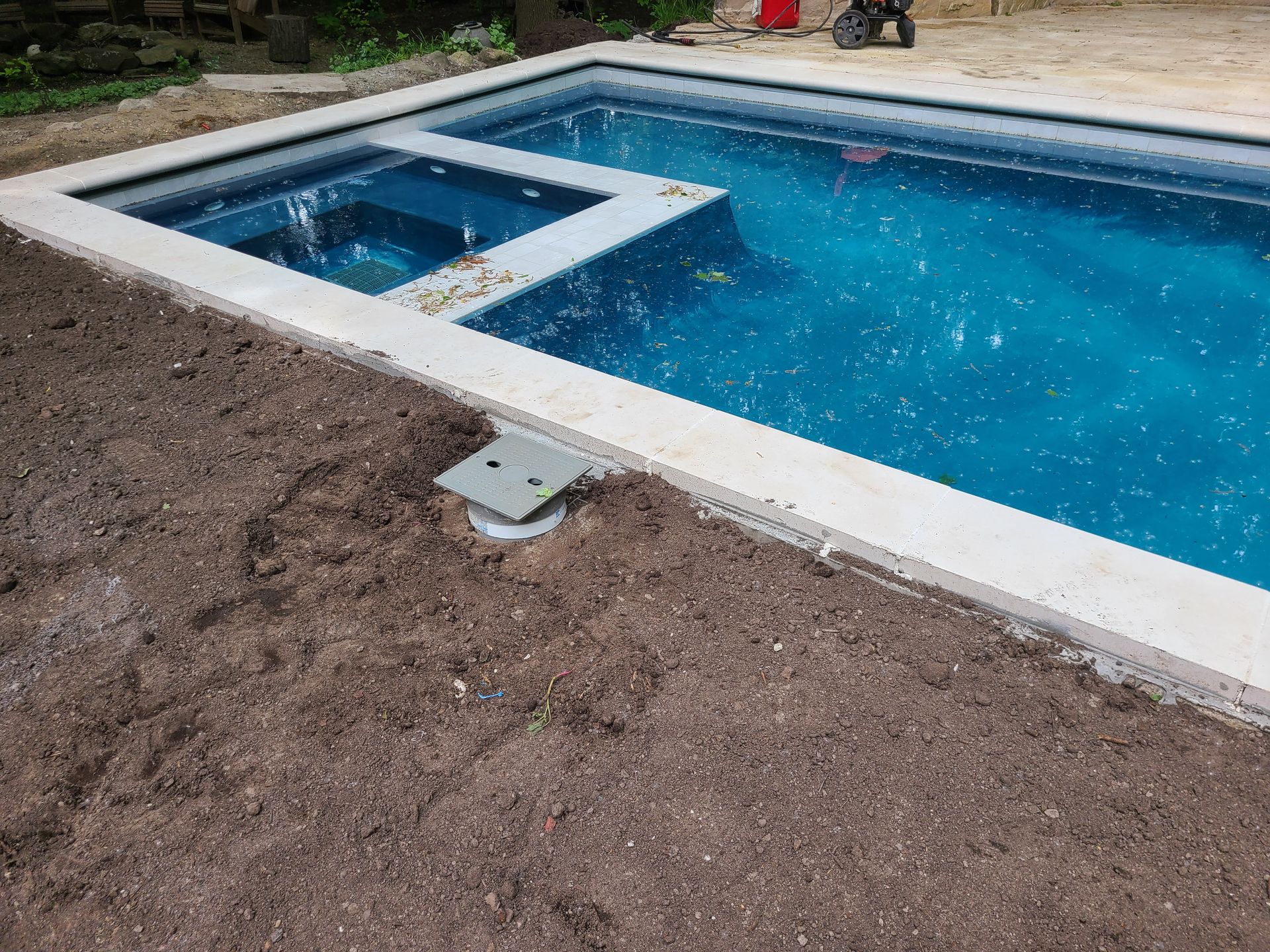 A swimming pool is being built in a backyard.