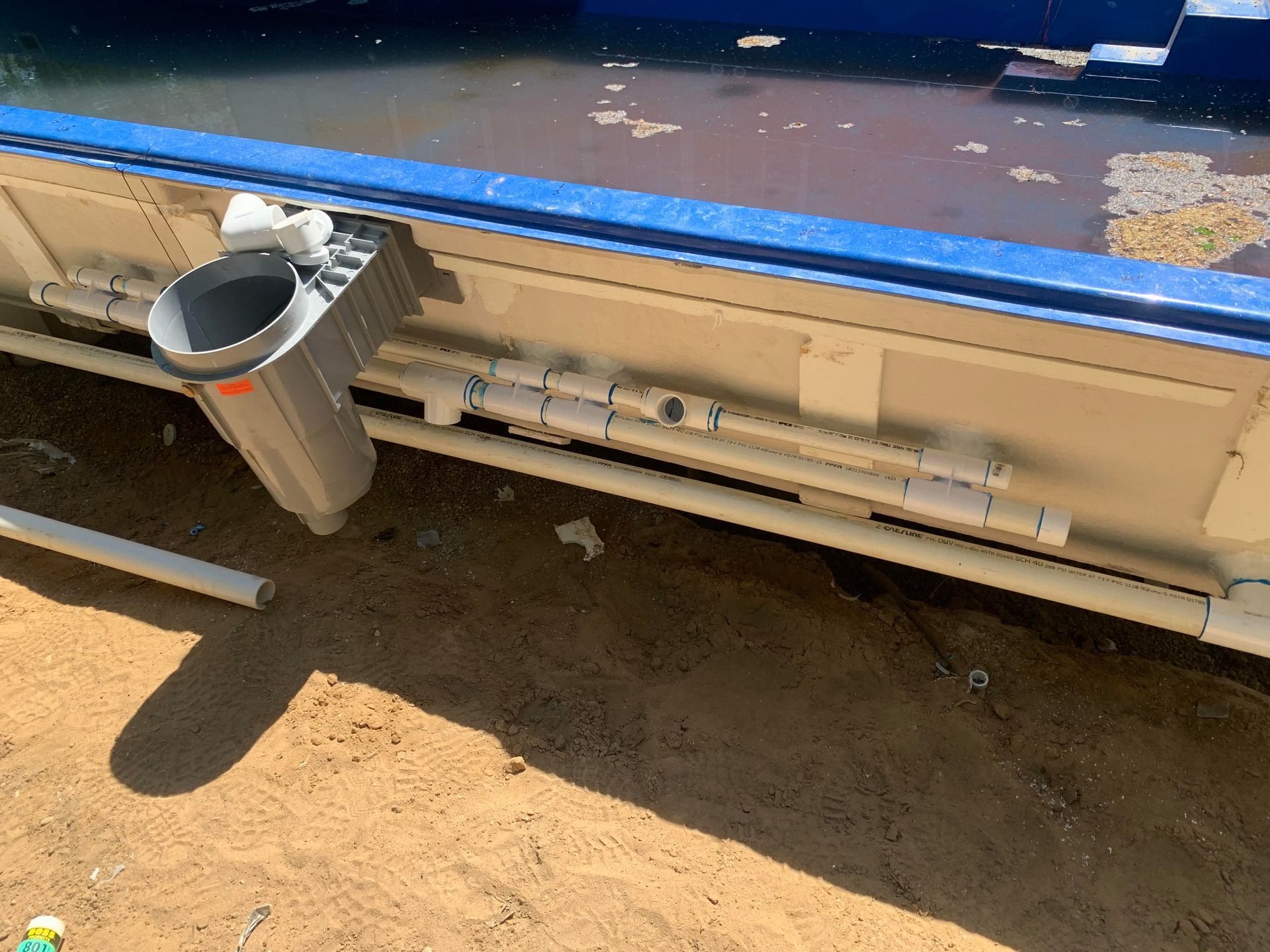 A trash can is attached to the side of a boat.