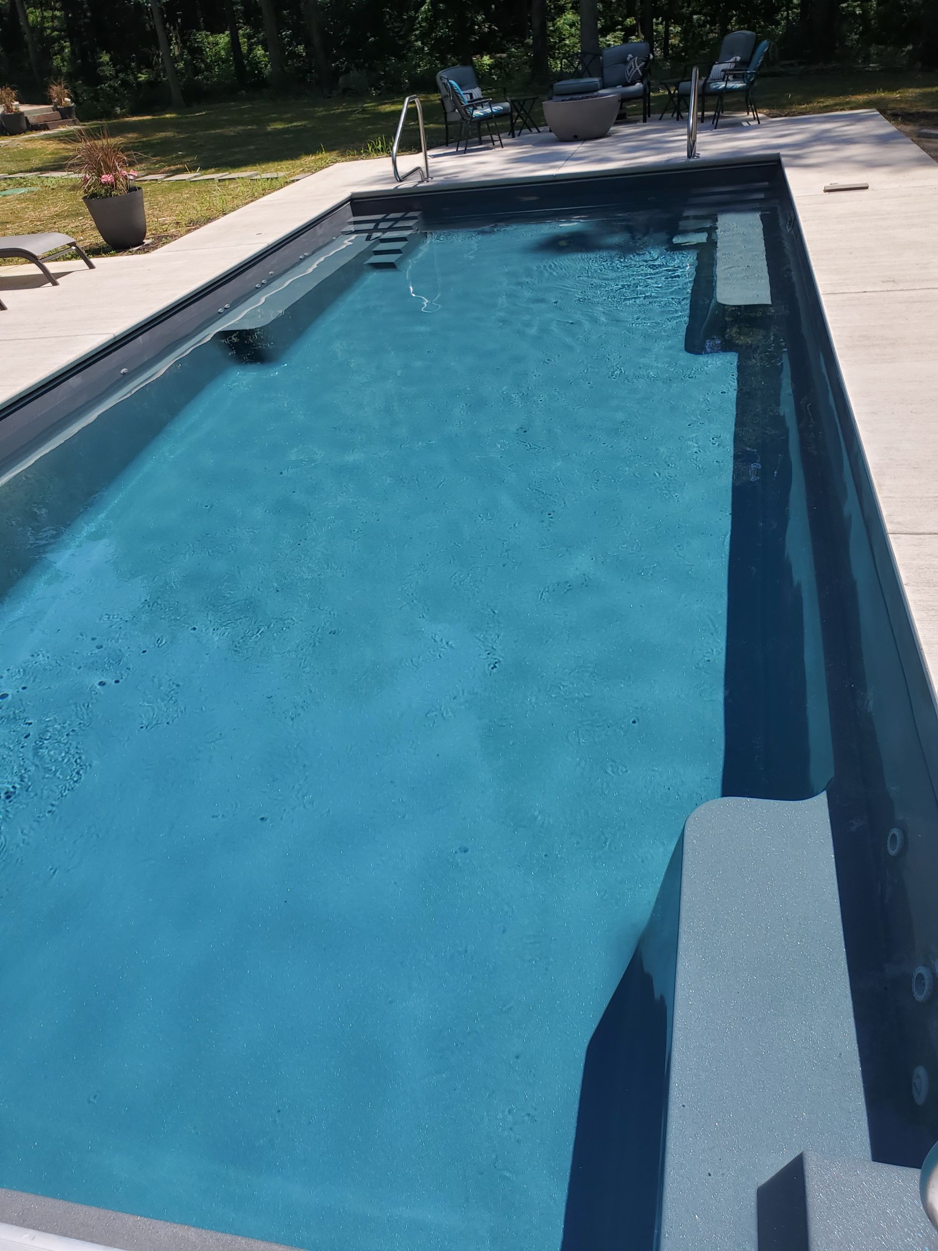 A large swimming pool filled with blue water.