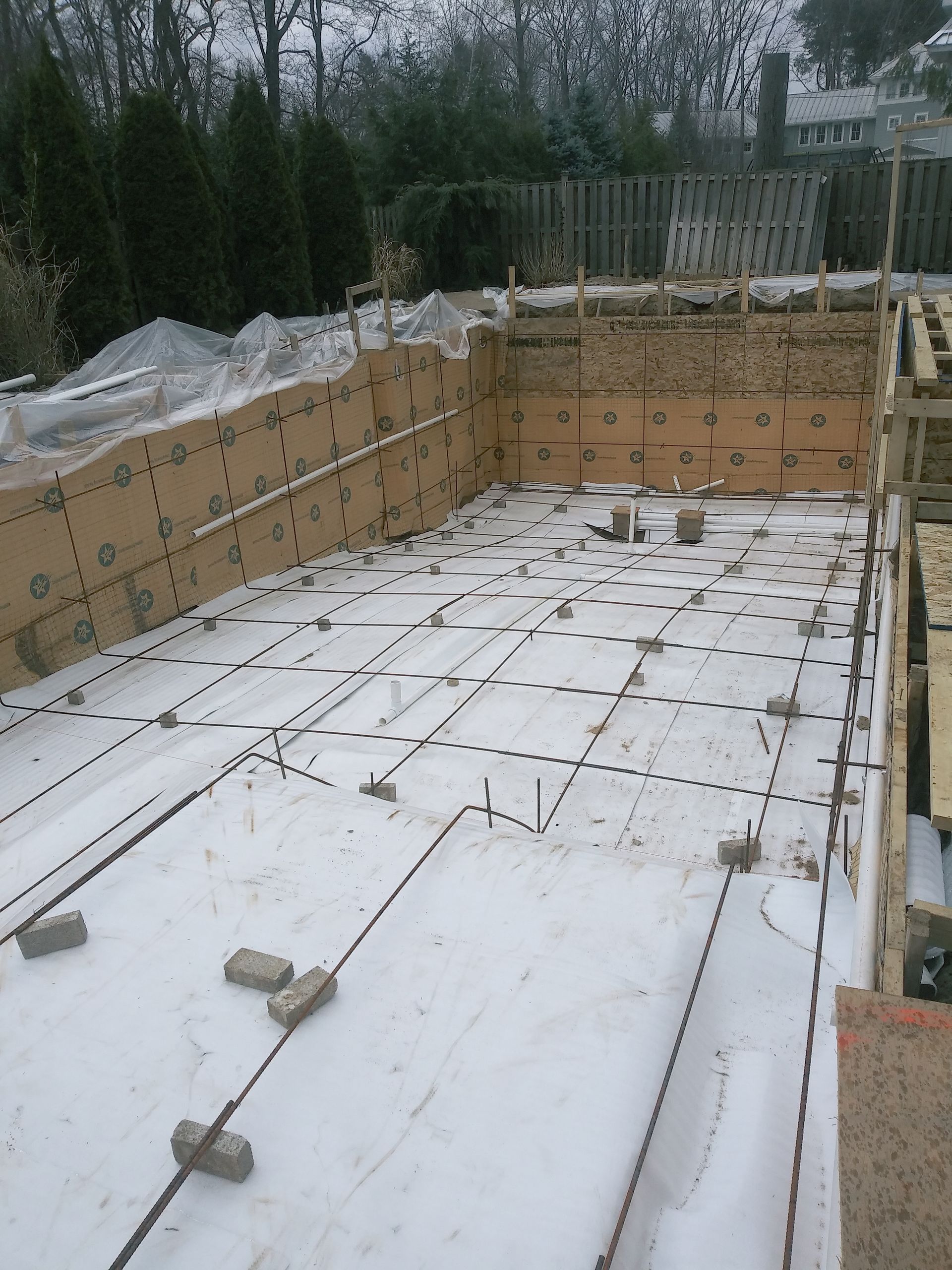A swimming pool is being built in the snow.