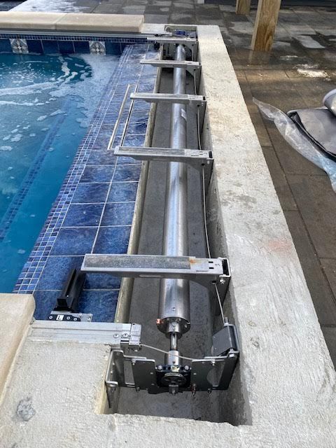 A swimming pool with a hose attached to the side of it.