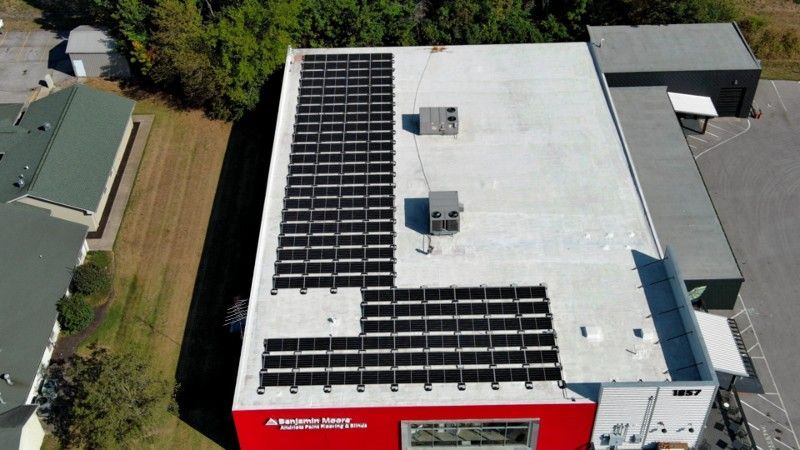 An aerial view of a building with solar panels on the roof