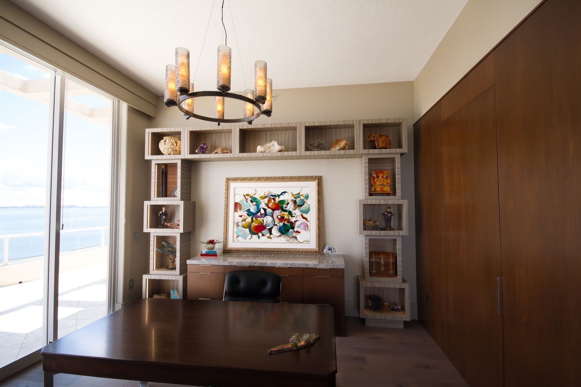 A room with a table and a picture on the wall