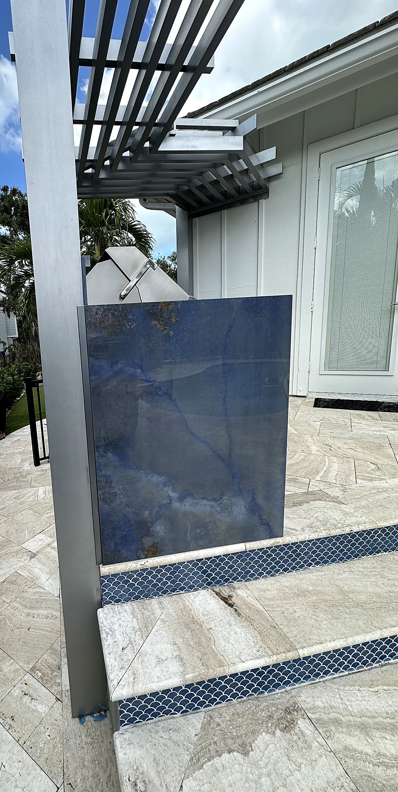Tall waterfall panel beside the pergola post