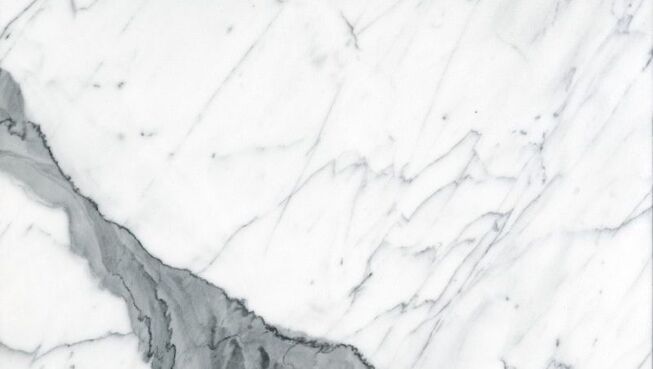 a close up of a white marble tile with a black vein