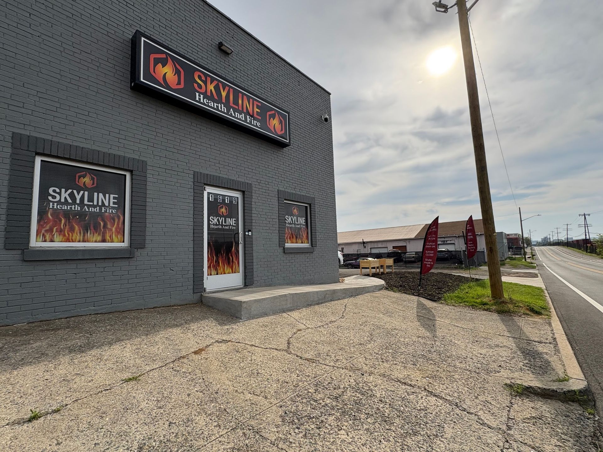 Skyline Hookah & Lounge exterior. Gray building with sign, door, and window displays; sunny day.