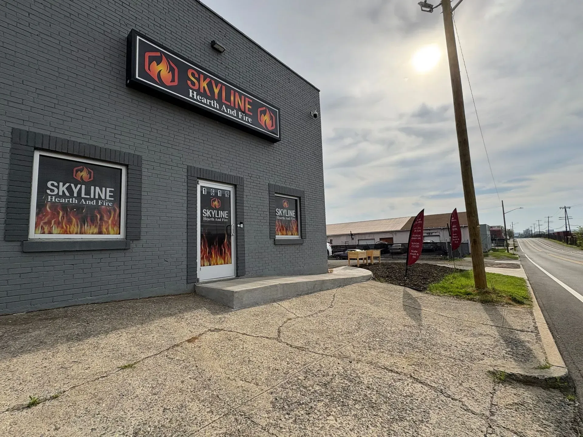 Gray building with "Skyline Hookah & Lounge" sign, door and windows. Sunny, daytime setting.