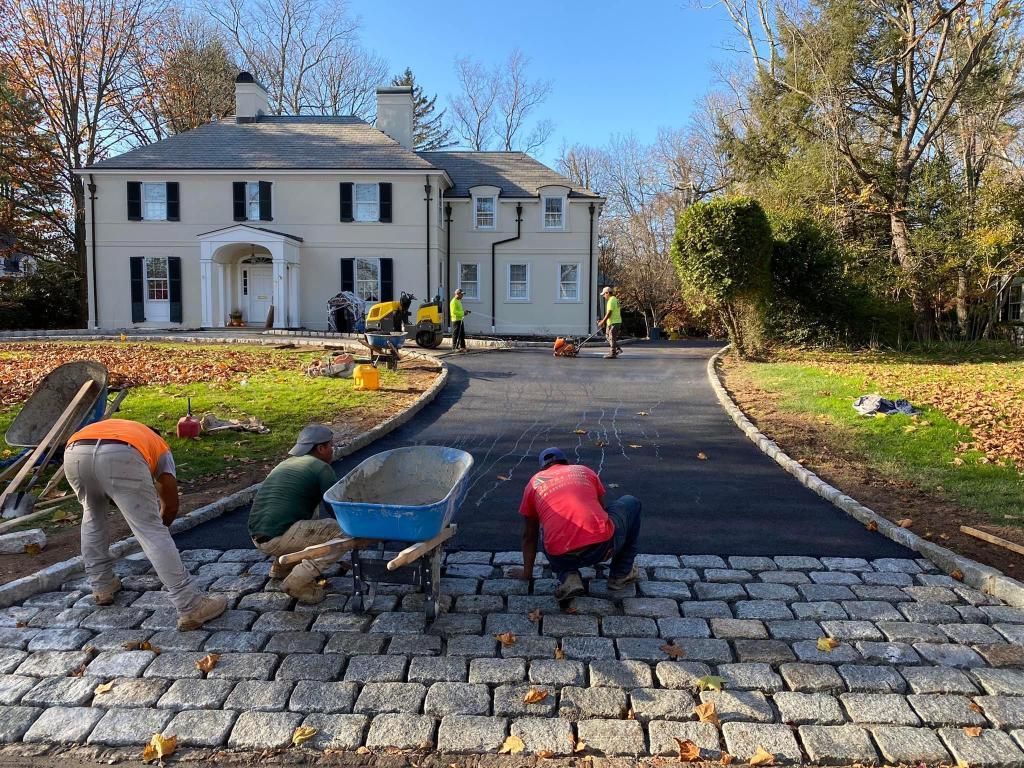 Asphalt driveway with stone tile end