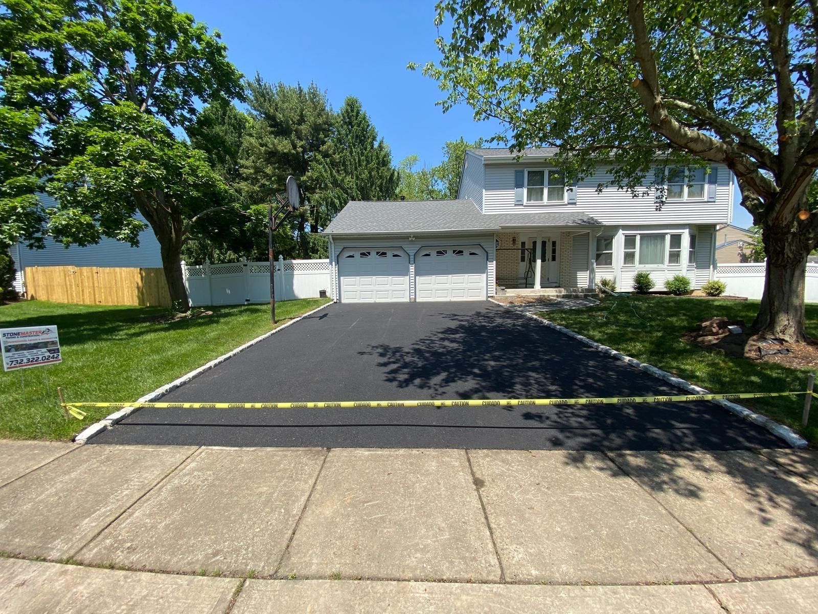 A house with a driveway that has been paved in front of it.
