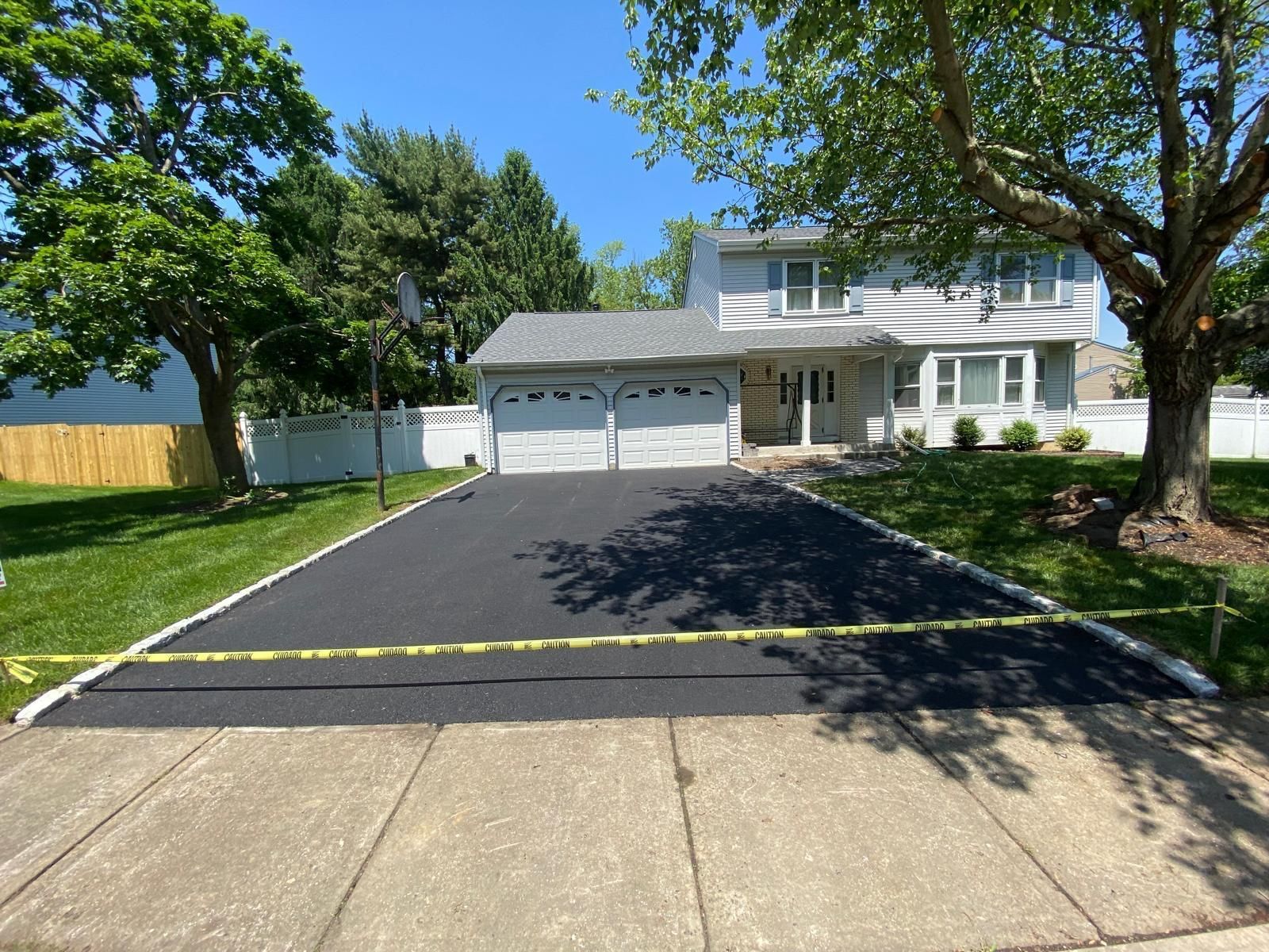 A house with a driveway that has been paved in front of it.