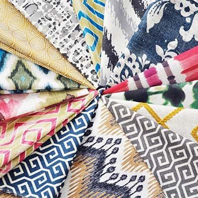 Colorful patterned fabric swatches arranged in a circular fan.