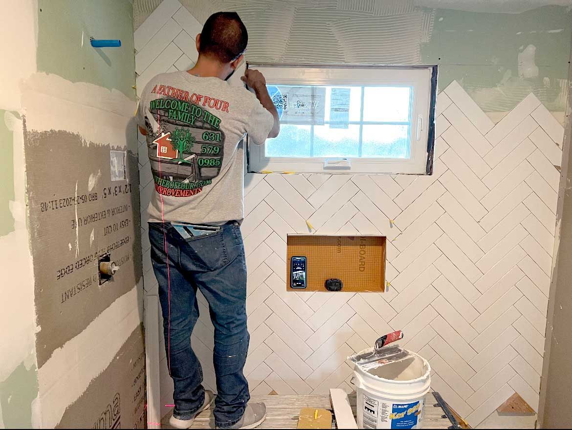 Man installing bathroom tiles