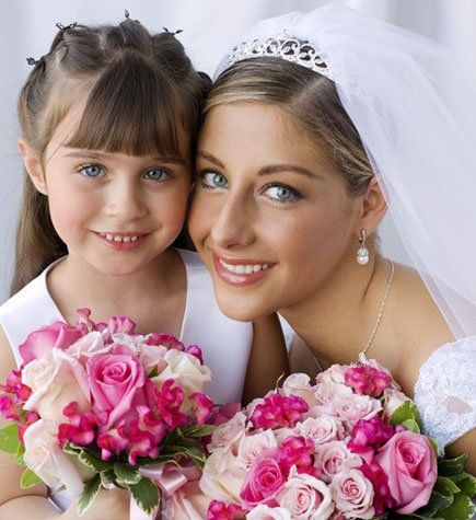 Bride and kid holding bouquet.