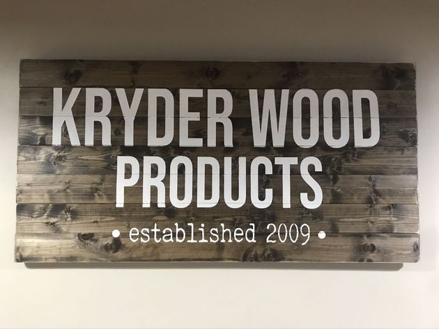 Rustic wooden sign reading “Kryder Wood Products,” with “established 2009” beneath.