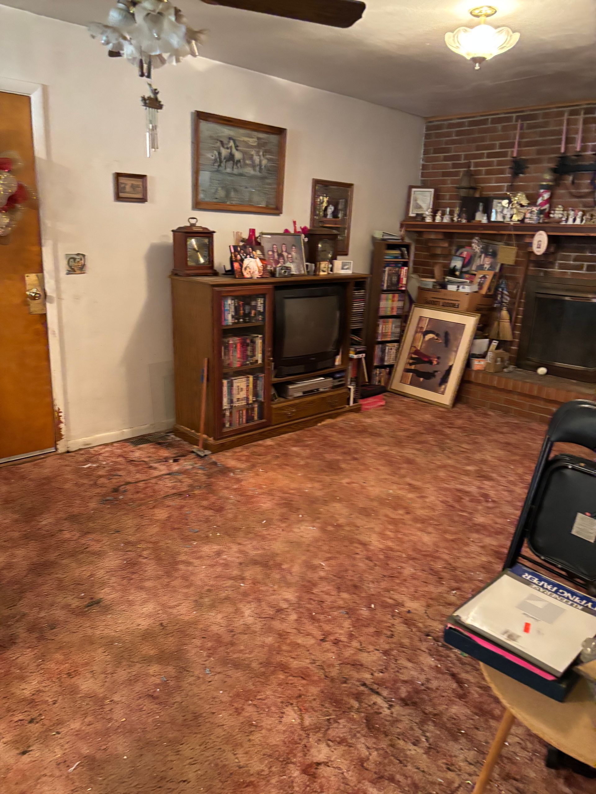 Living room with TV and brick fireplace-after