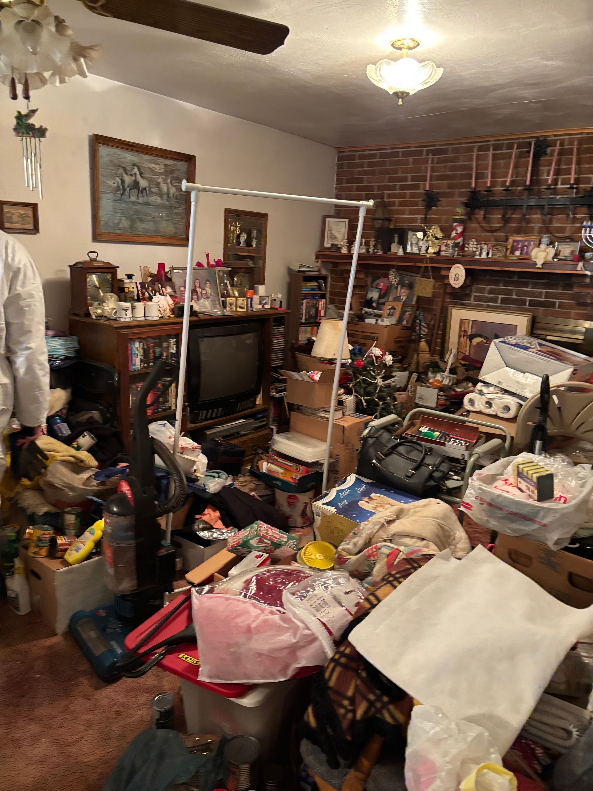 Living room with TV and brick fireplace-before
