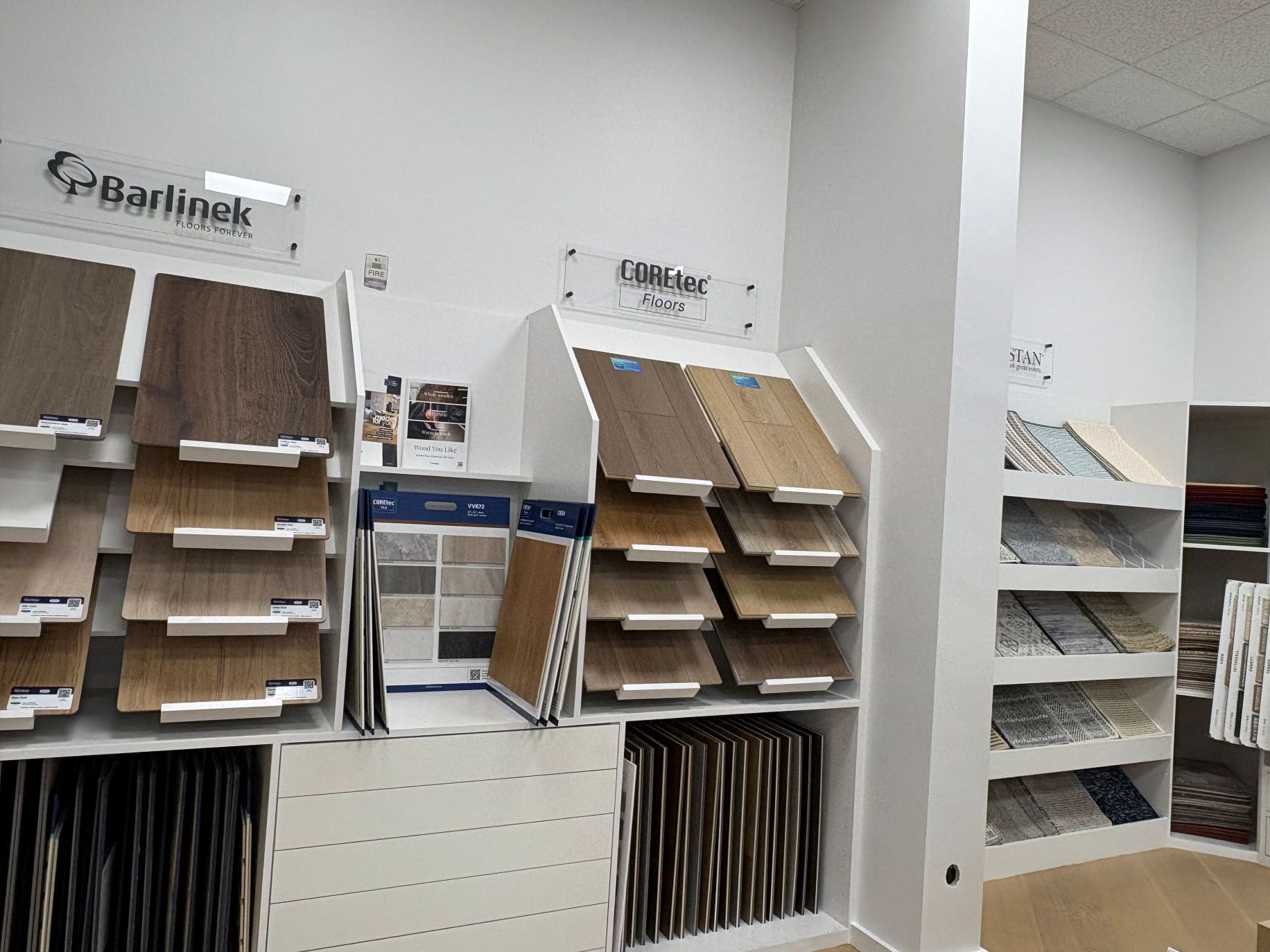 Office supply display with stacked paper trays, folders, and file organizers on white shelves