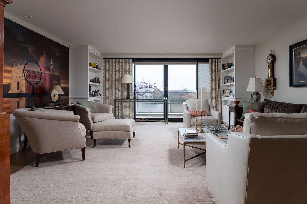Bright living room with beige seating, a large window, and a city view