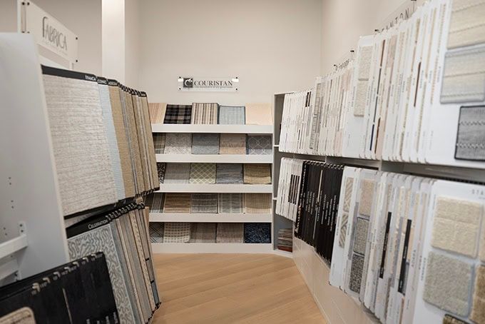 Rows of open books and documents displayed on shelves in a quiet archive room