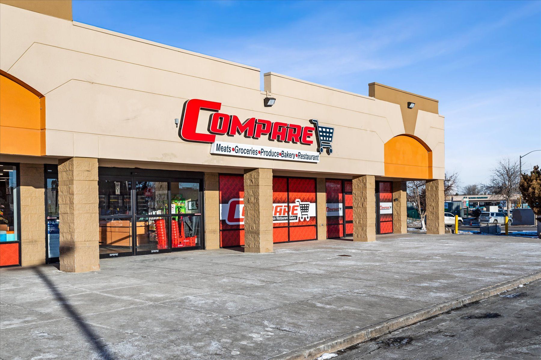 A store front with a large red sign that says ' compere ' on it.