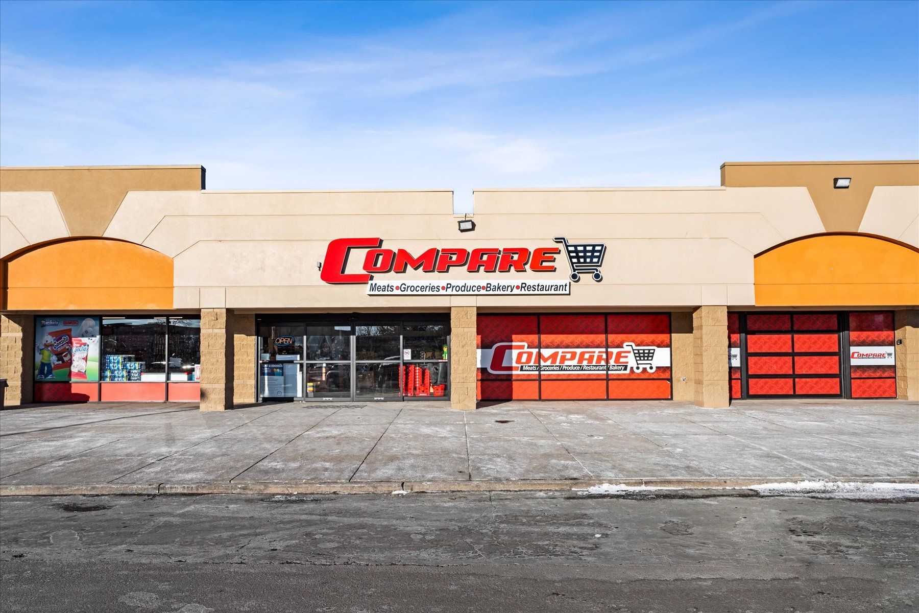 The outside of a compare grocery store on a sunny day