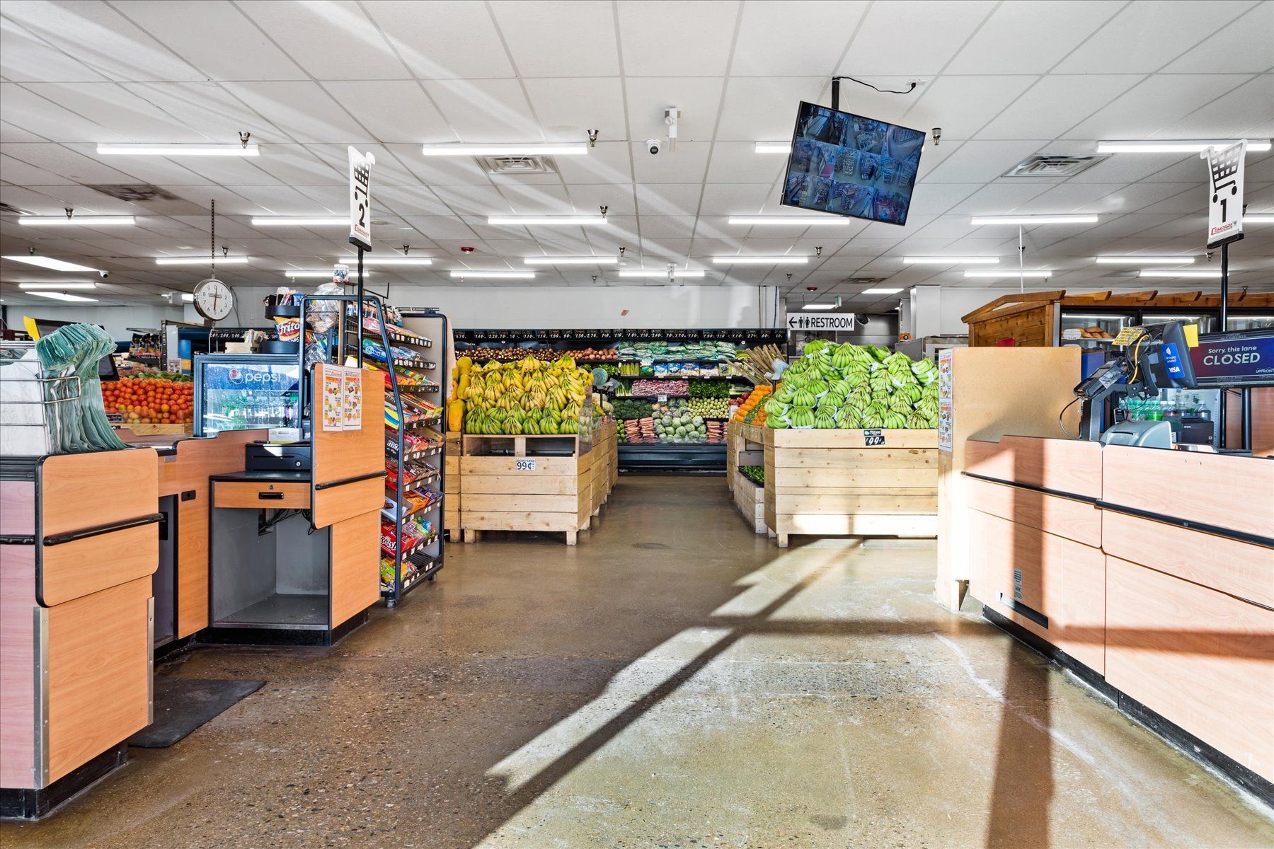 The inside of a grocery store with a lot of fruits and vegetables.