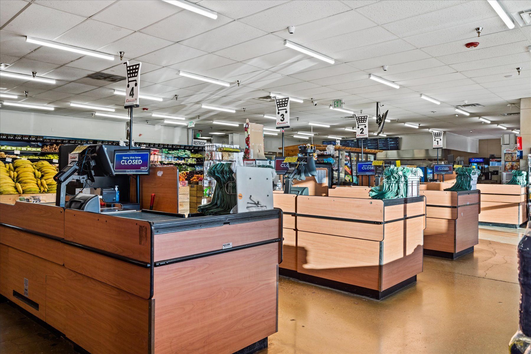 The inside of a grocery store with a row of cash registers.