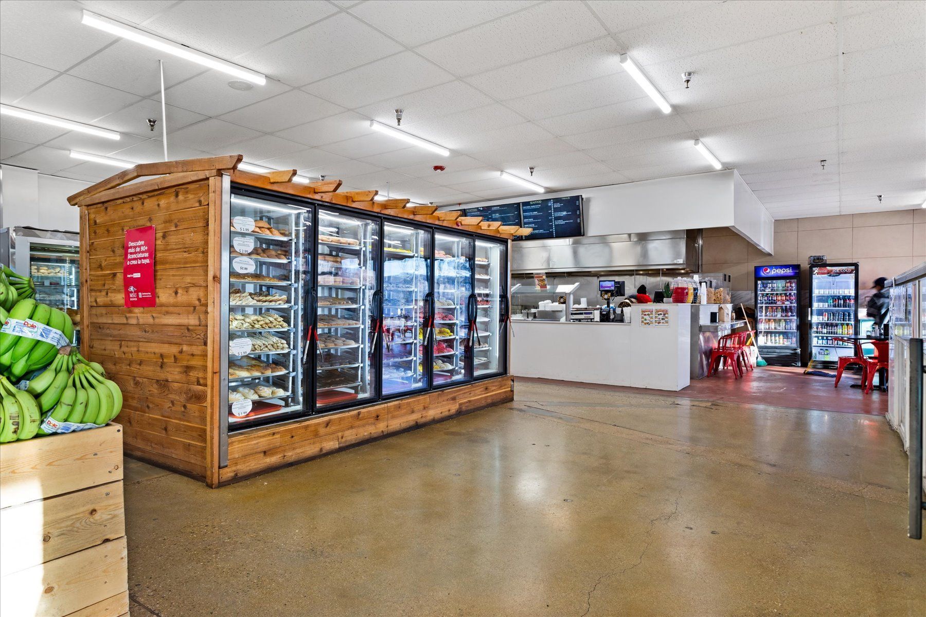 The inside of a grocery store with a wooden kiosk in the middle.