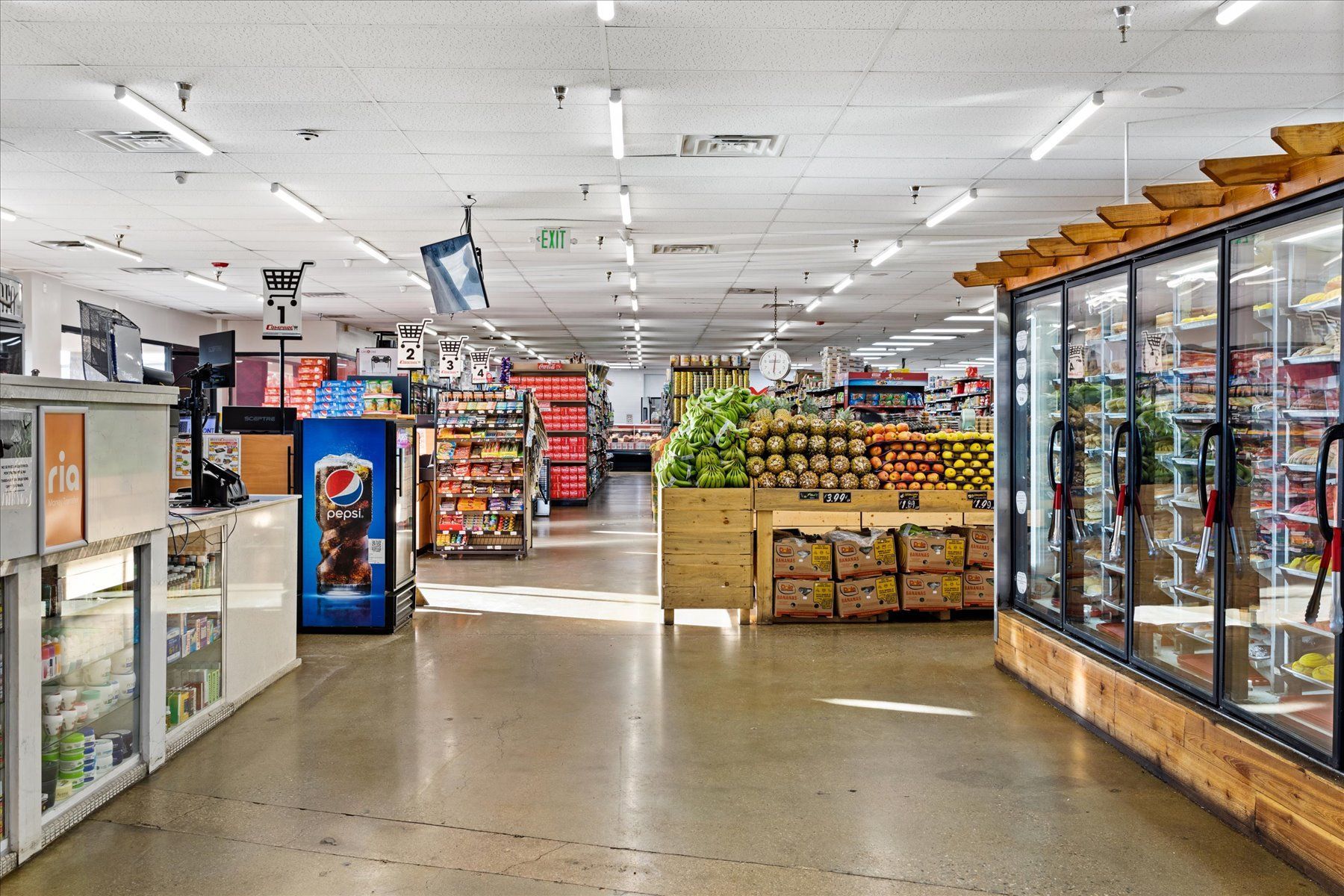 The inside of a grocery store with a pepsi machine.