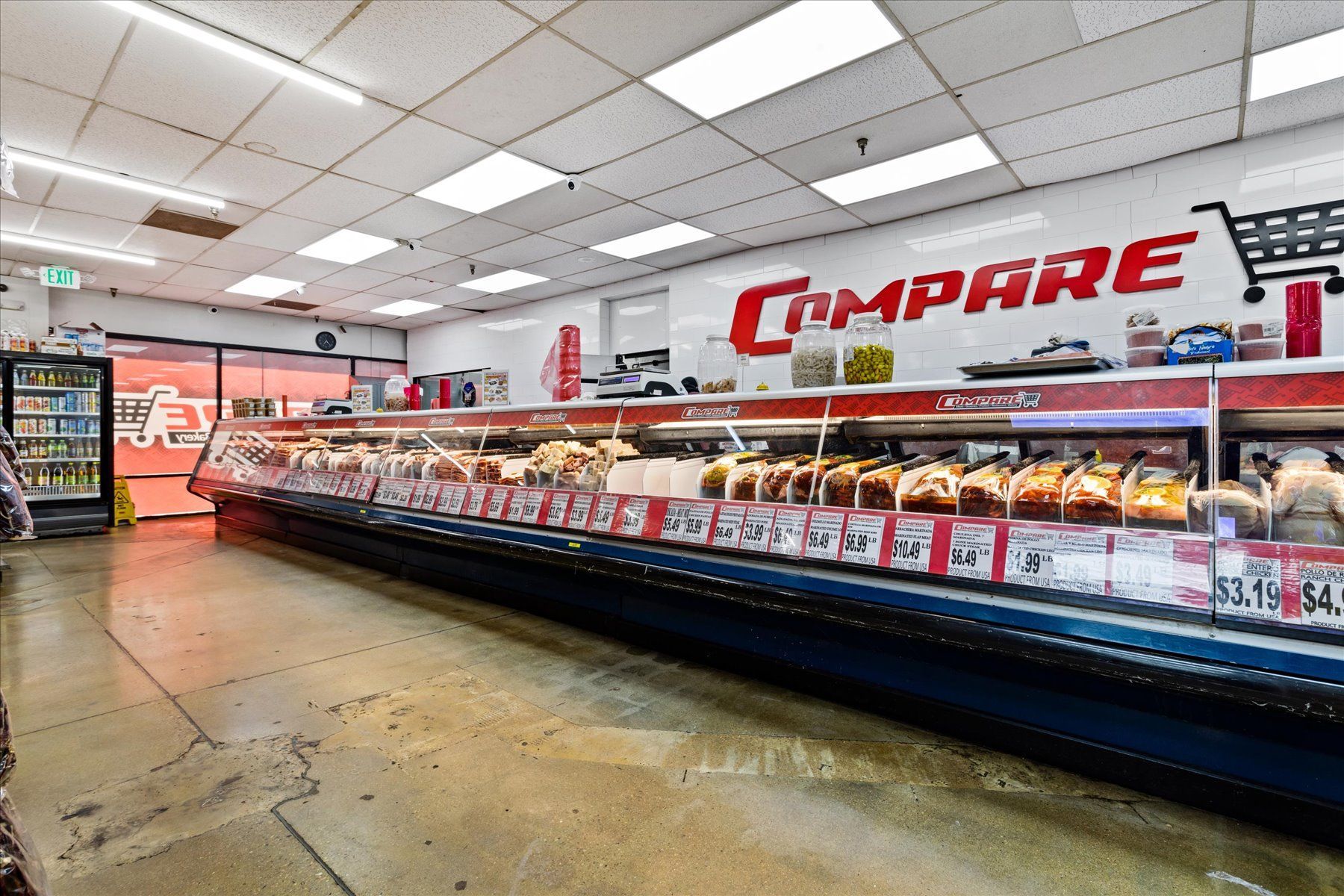 The inside of a grocery store with a sign that says `` compare ''.
