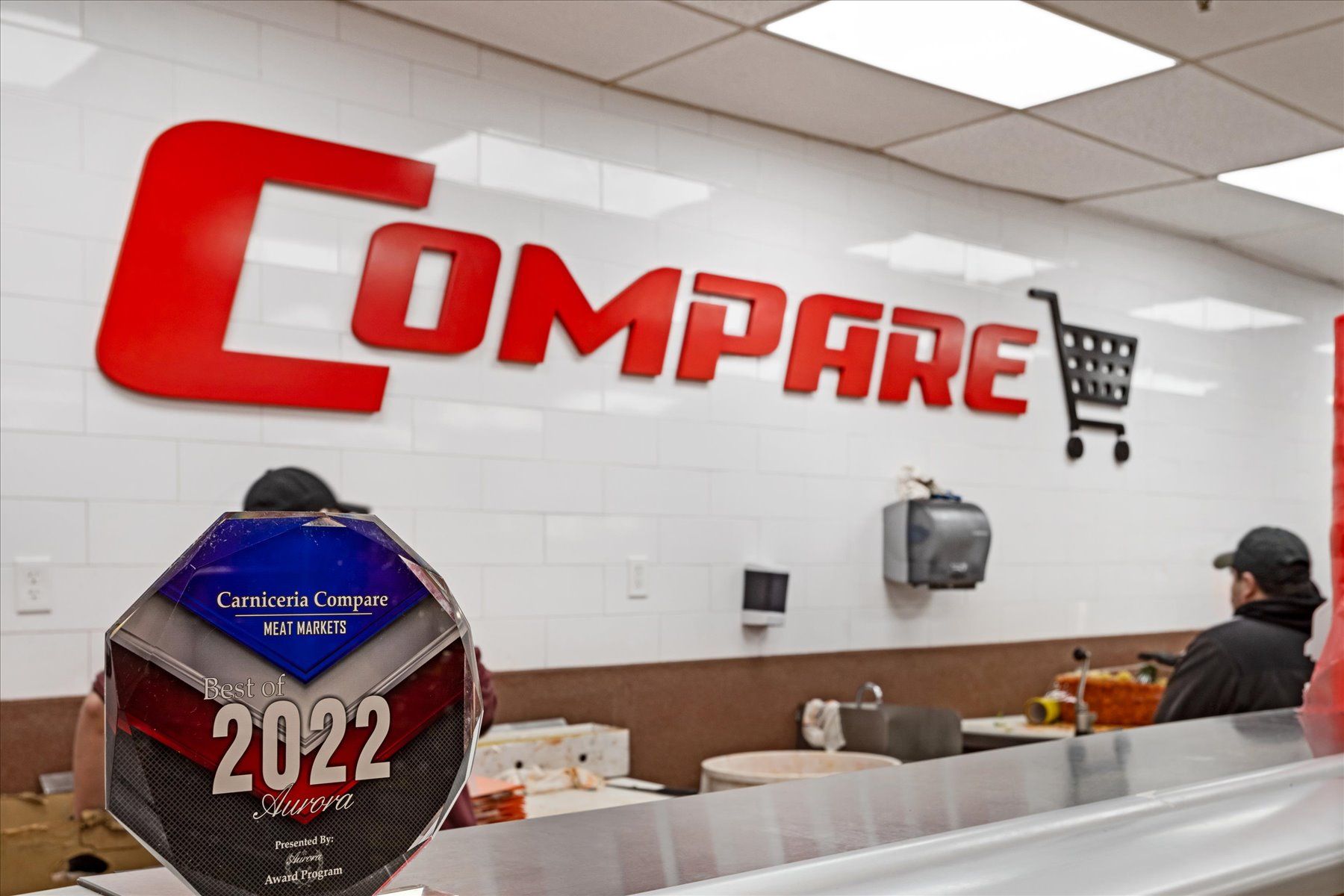 A man is standing in front of a sign that says compare 2022