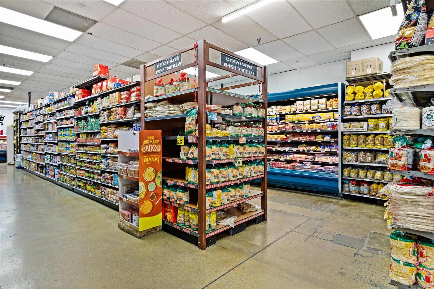 The inside of a grocery store filled with lots of shelves.