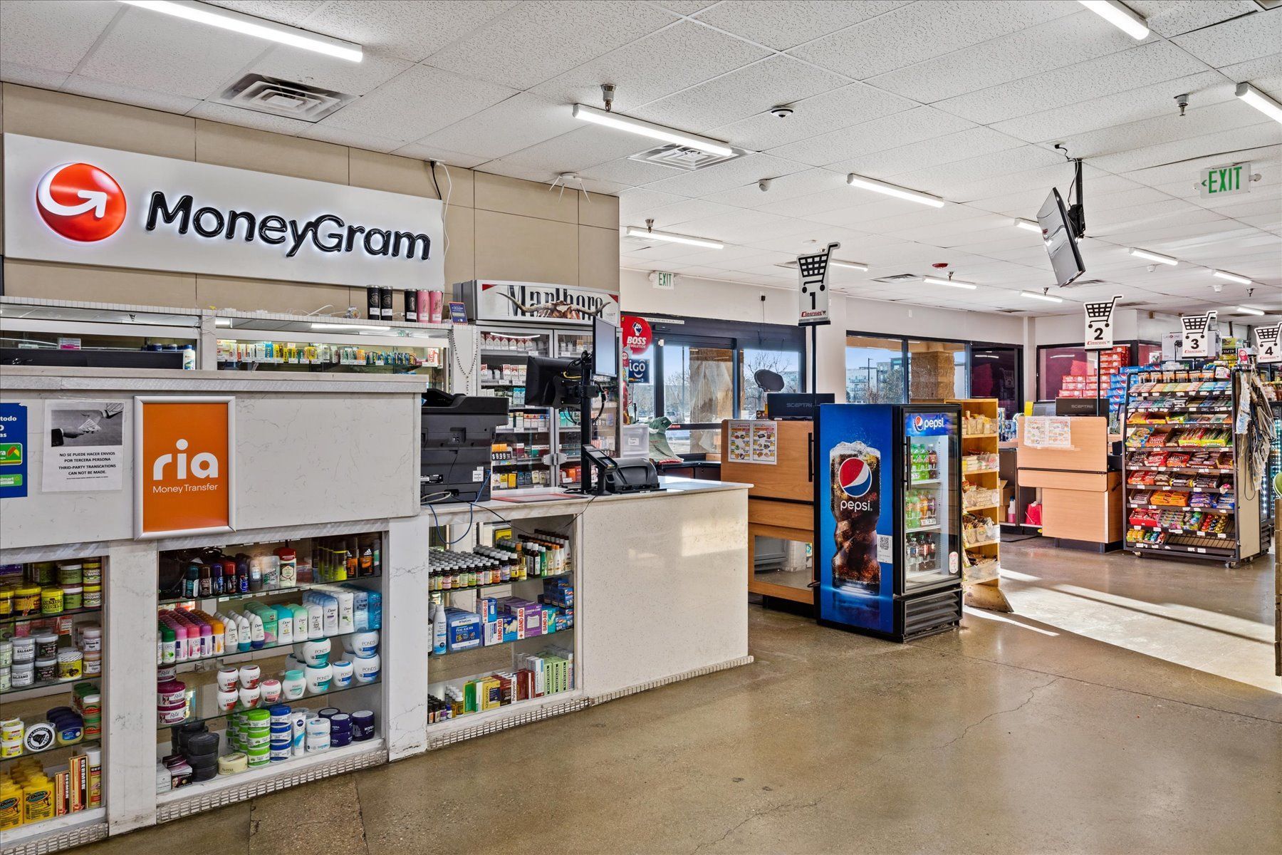 The inside of a convenience store with a Moneygram sign on the wall