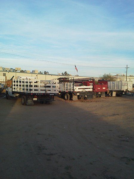 Four trucks parked in a lot